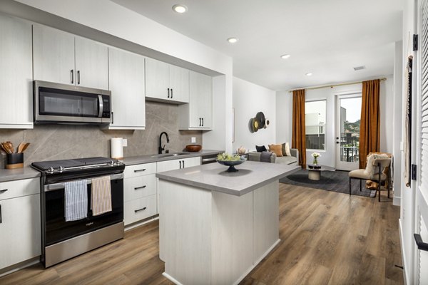 Modern kitchen with stainless steel appliances at Vora Lux Apartments