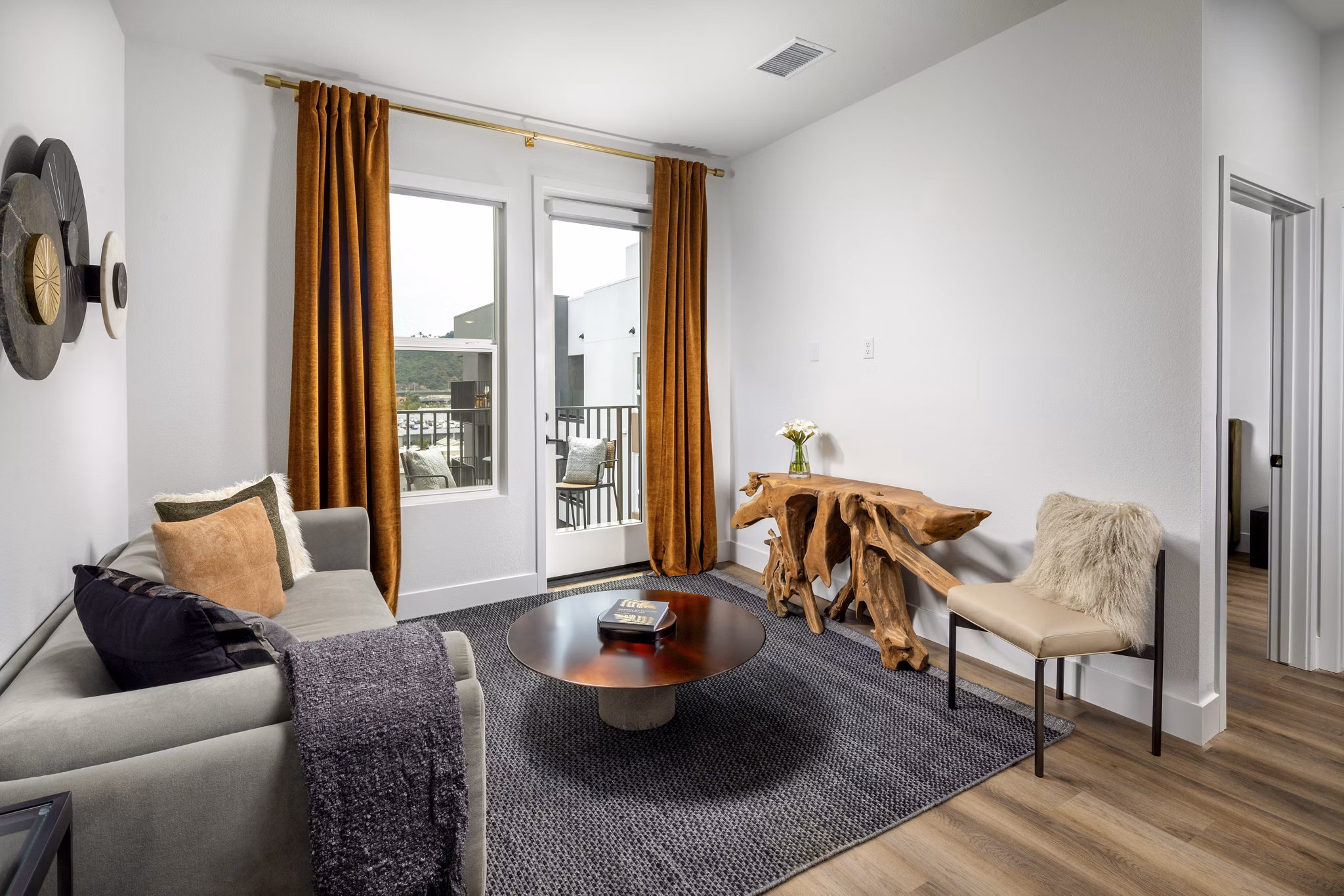 Contemporary living room with stylish decor and natural light at Vora Lux Apartments