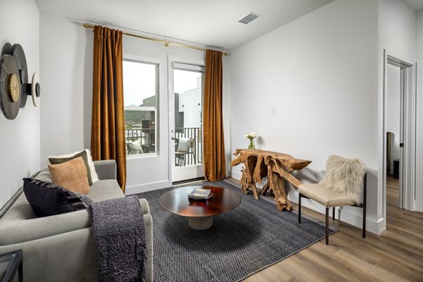 Contemporary living room with stylish decor and natural light at Vora Lux Apartments