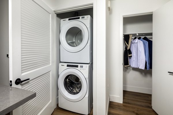 Efficient laundry room with modern washers and dryers at Vora Lux Apartments