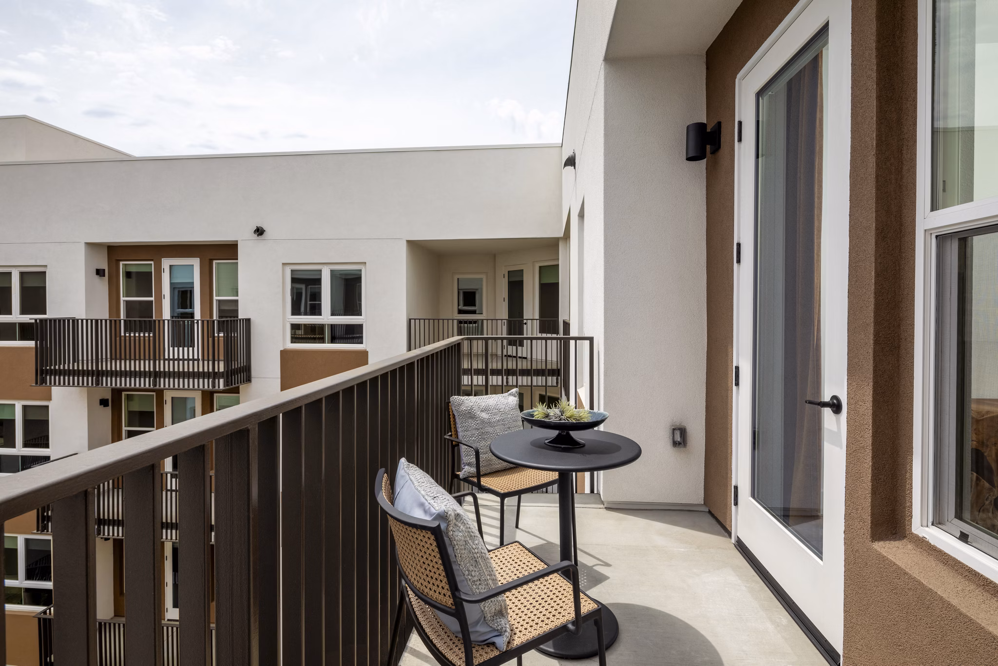 Chic patio with outdoor seating and scenic views at Vora Lux Apartments