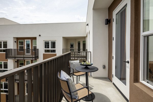 Chic patio with outdoor seating and scenic views at Vora Lux Apartments