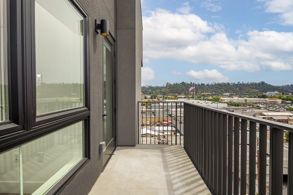 Patio area with stylish outdoor seating and landscaped surroundings at Vora Lux Apartments, ideal for relaxation and social gatherings