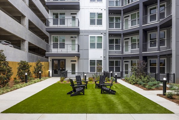 Courtyard patio with modern seating and lush greenery at Broadstone 2Thirty Apartments