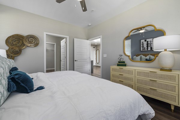 Bedroom featuring modern design and cozy decor at Everly on 401 Apartments