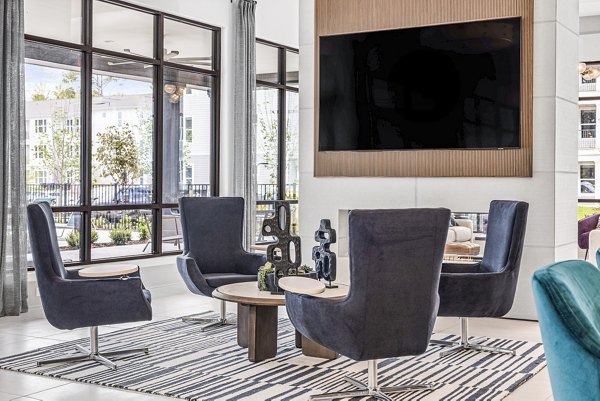 Clubhouse lobby featuring modern decor and co-working spaces at Everly on 401 Apartments, a Greystar luxury community