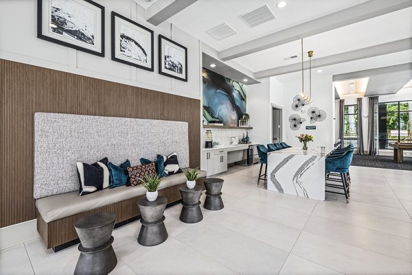 Clubhouse with stylish seating and recreation areas at Everly on 401 Apartments, offering luxury communal spaces