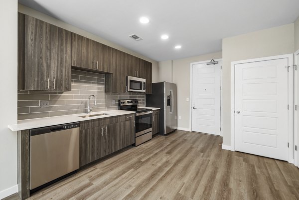 Sleek kitchen design with modern appliances at Everly on 401 Apartments