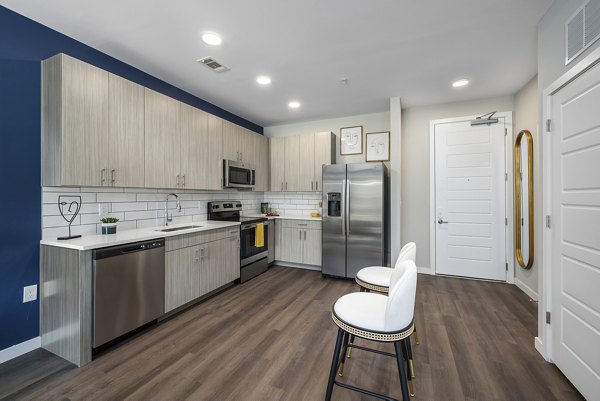 Modern kitchen featuring stainless steel appliances in Everly on 401 Apartments