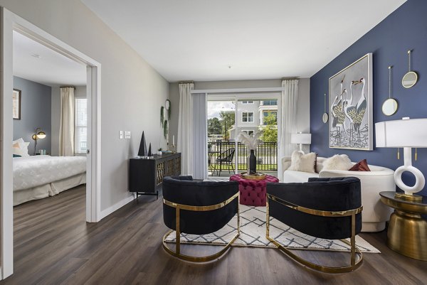 Spacious living room with modern decor at Everly on 401 Apartments