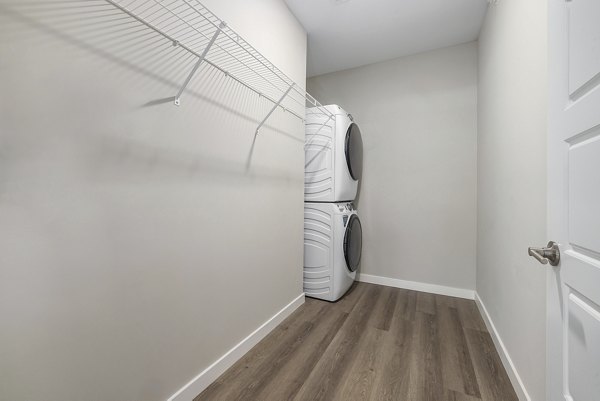 Laundry room equipped with modern appliances at Everly on 401 Apartments