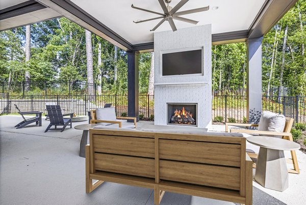 Cozy fire pit on patio at Everly on 401 Apartments, ideal for outdoor relaxation and social gatherings in a luxury setting