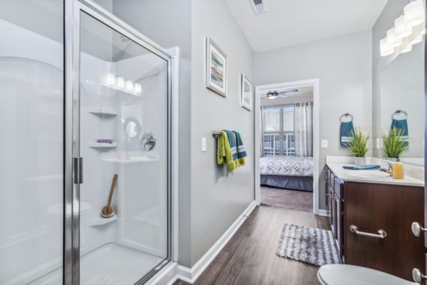 Modern bathroom with sleek fixtures and elegant tiling at Level at 401 Apartments