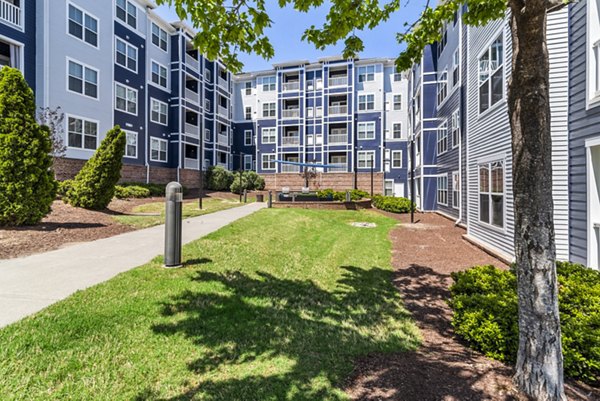 Stylish courtyard patio with grilling area at Level at 401 Apartments, a luxury Greystar property