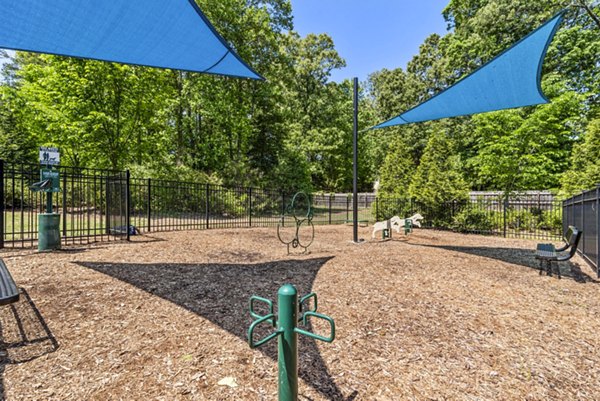Dog-friendly park at Level at 401 Apartments featuring lush green spaces and pet amenities, perfect for urban pet owners