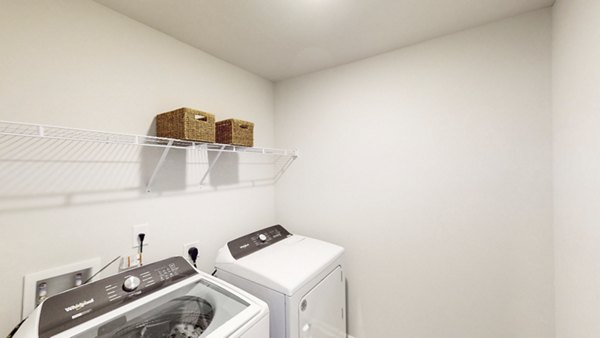 Laundry room featuring modern appliances at The Springs at Arcadia Apartments