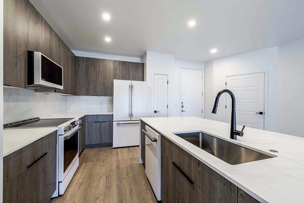Modern kitchen with stainless steel appliances in Slate Scottsdale Apartments