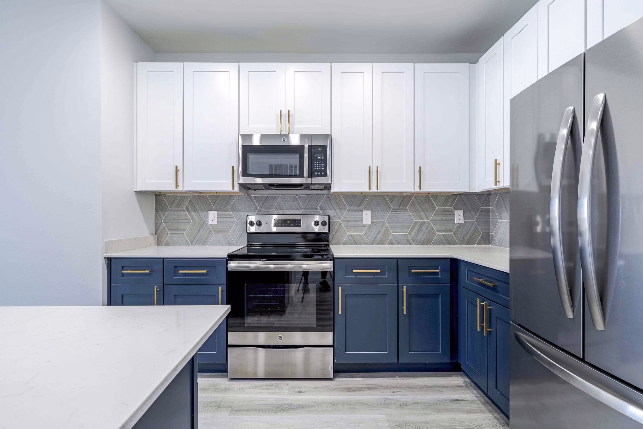 Sleek modern kitchen with granite countertops and stainless steel appliances at Slate Scottsdale Apartments