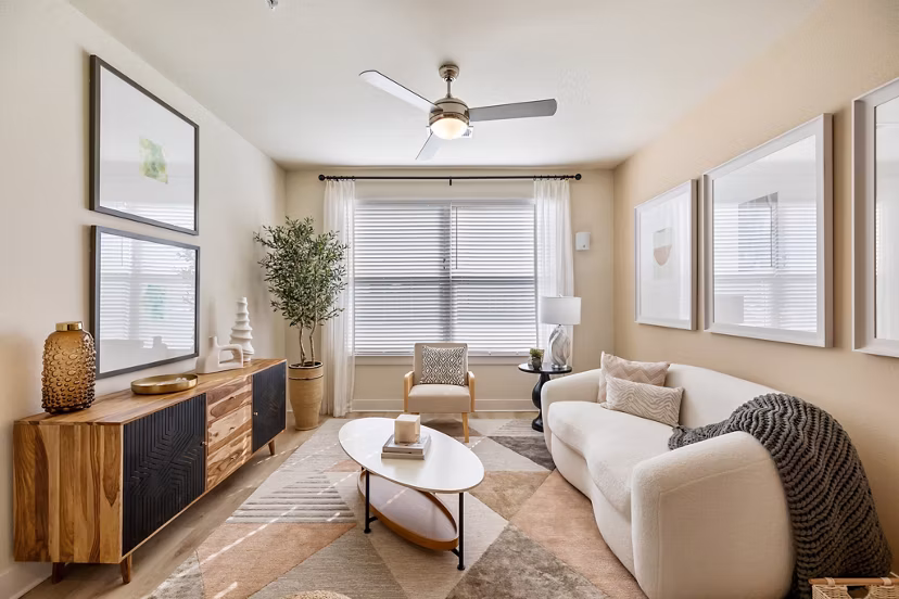Living room with contemporary furniture and large windows at Birchway Perry Road Apartments, offering luxury living spaces