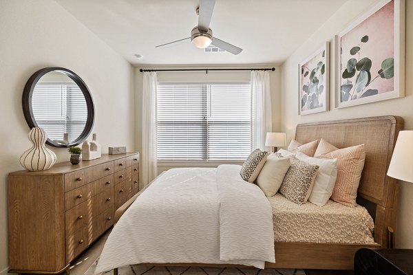 Cozy bedroom with modern decor at Birchway Perry Road Apartments, featuring elegant design and ample natural light for a luxurious living experience