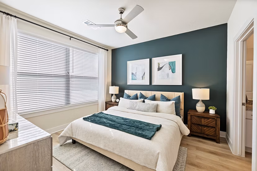 Spacious bedroom with modern decor at Birchway Perry Road Apartments, featuring plush bedding and natural light for luxury living