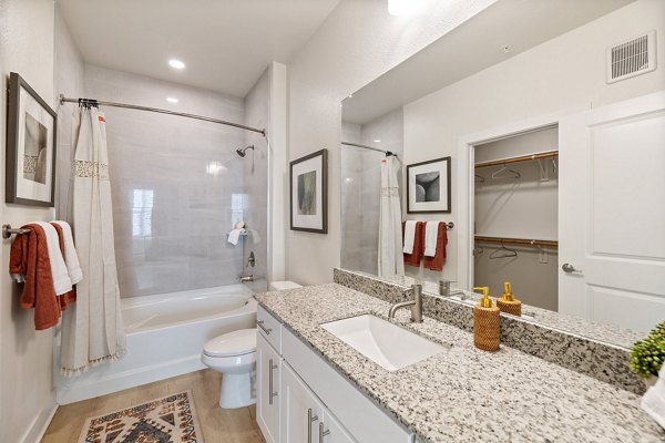 Modern bathroom with sleek fixtures in Birchway Perry Road Apartments
