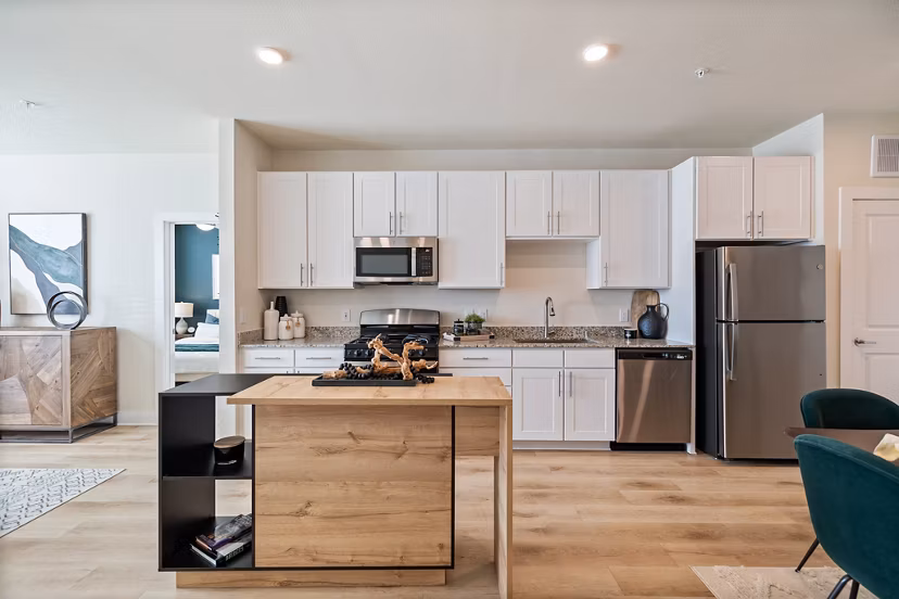Modern kitchen with stainless steel appliances at Birchway Perry Road Apartments