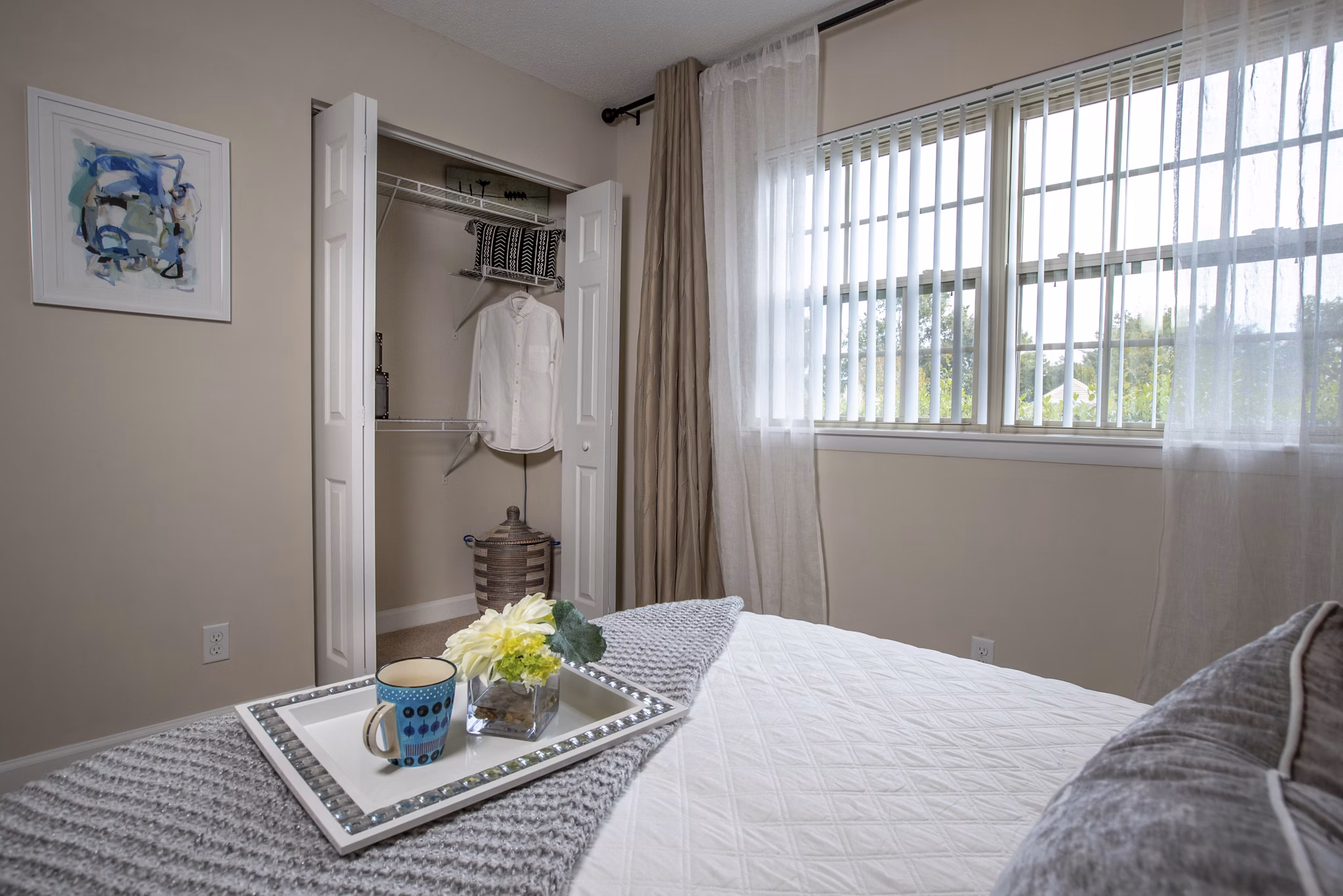 Bedroom with contemporary decor at Collins Crossing Apartments in Greystar luxury community