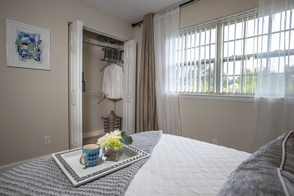 Bedroom with contemporary decor at Collins Crossing Apartments in Greystar luxury community
