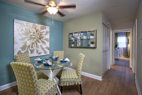 Dining room with modern fixtures and elegant seating in Collins Crossing Apartments, a Greystar luxury community