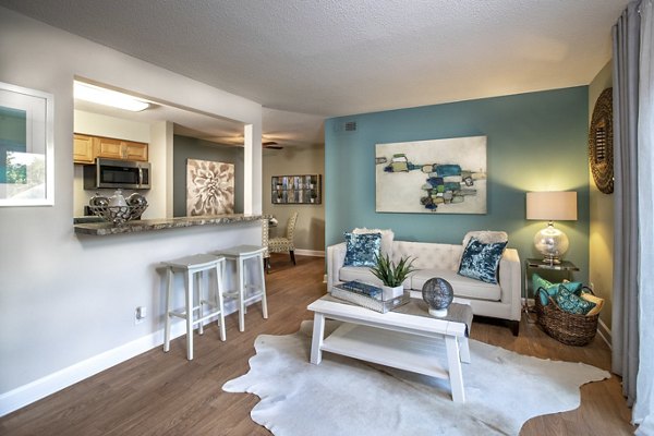 Spacious living room with modern decor at Collins Crossing Apartments