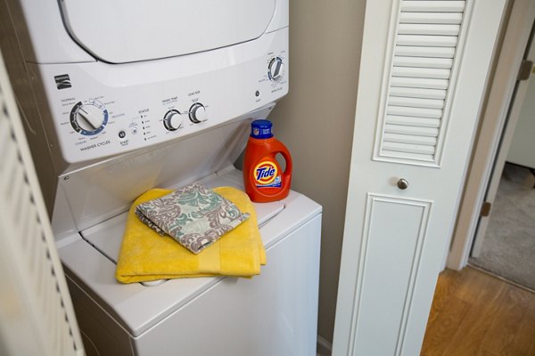Laundry room with modern appliances at Collins Crossing Apartments