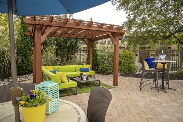 Inviting poolside patio area with lounge chairs at Collins Crossing Apartments