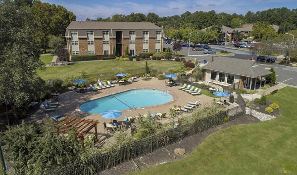 Sparkling outdoor pool at Collins Crossing Apartments offering luxury relaxation