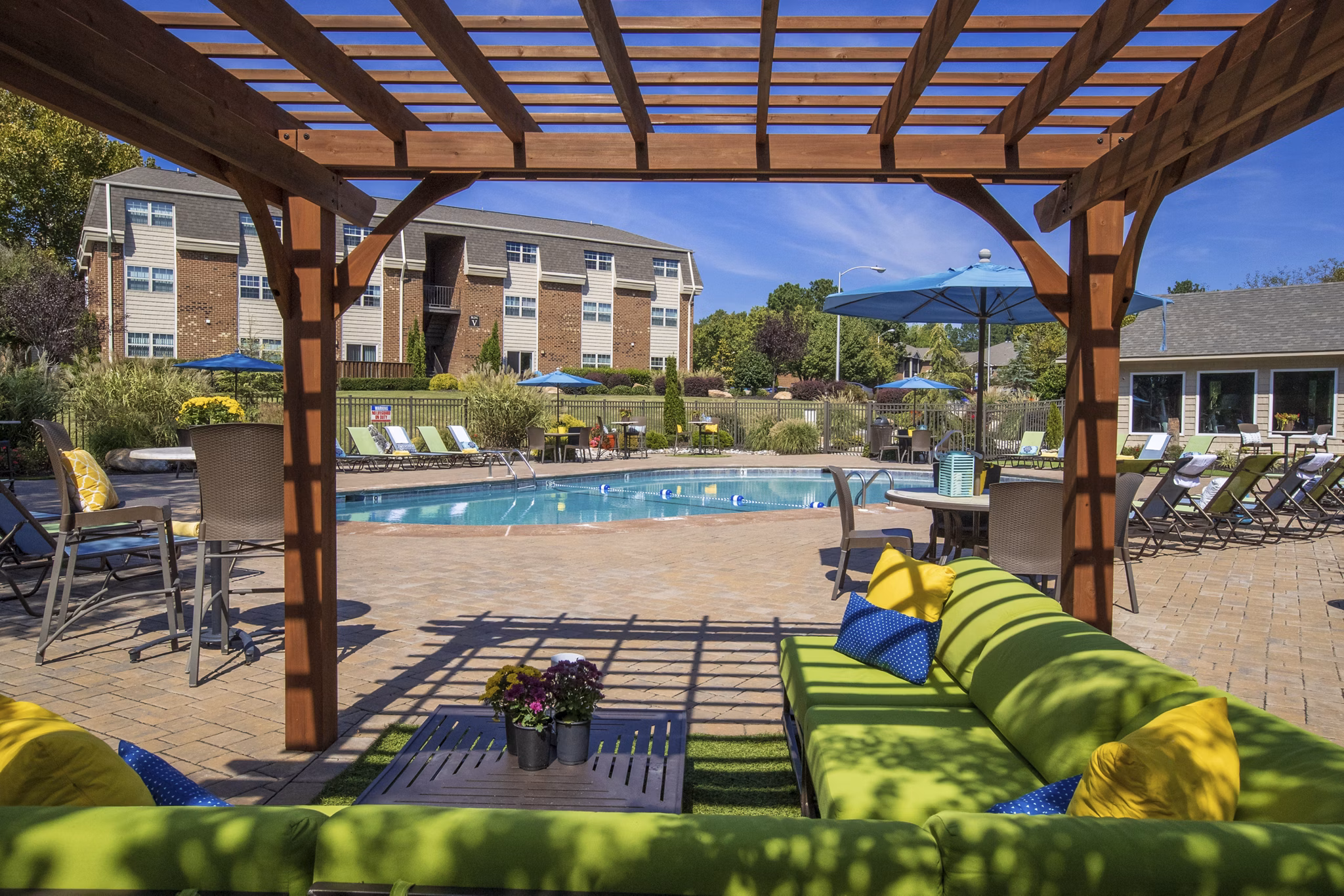 Relaxing pool at Collins Crossing Apartments with luxury loungers and landscaped surroundings