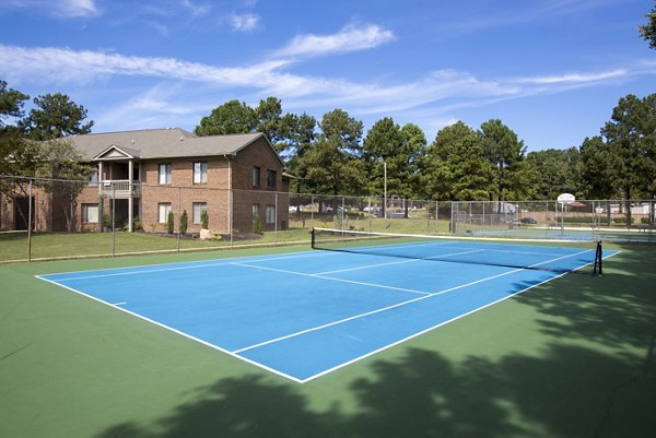 Modern tennis court at Collins Crossing Apartments: Enjoy active living in a vibrant community setting