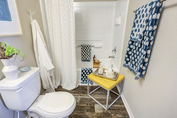 Bathroom featuring stylish vanity and modern fixtures at Fusion Apartments