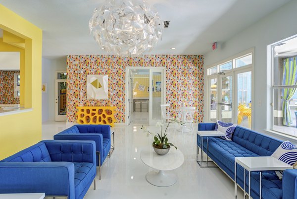 Modern clubhouse with stylish seating and entertainment options at Fusion Apartments