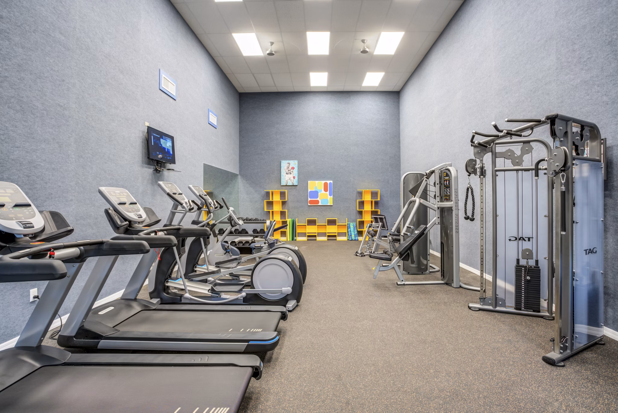 State-of-the-art fitness center at Fusion Apartments featuring modern equipment and spacious workout areas for residents