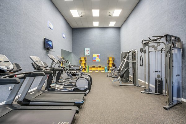State-of-the-art fitness center at Fusion Apartments featuring modern equipment and spacious workout areas for residents