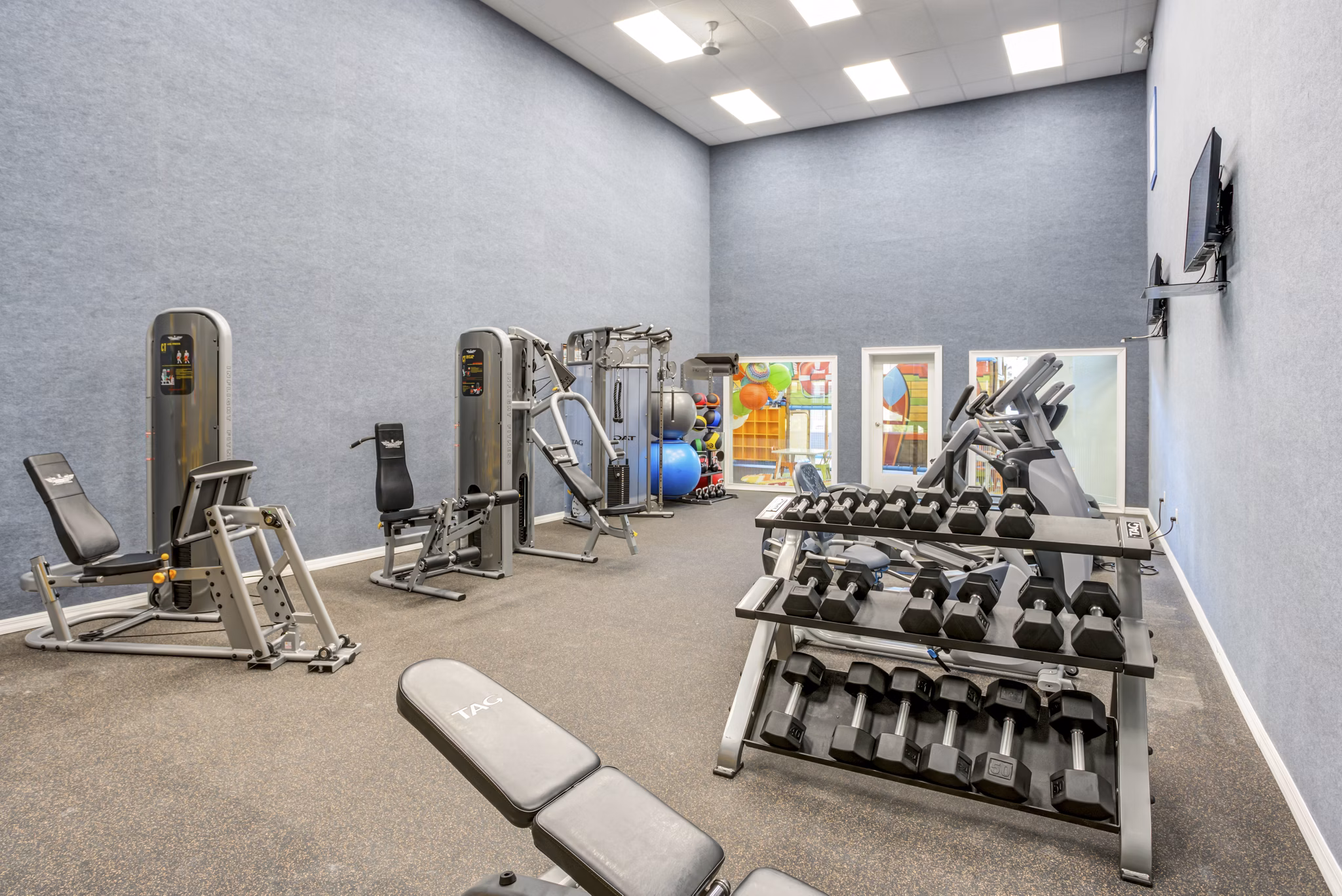 Fitness center at Fusion Apartments: State-of-the-art gym facilities with modern equipment for residents seeking an active lifestyle