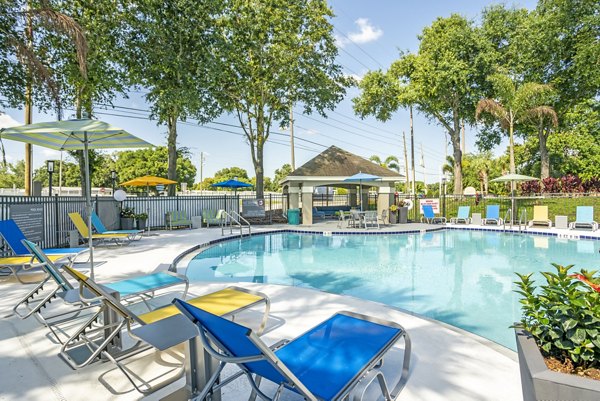 Resort-style pool with lounge chairs at Fusion Apartments