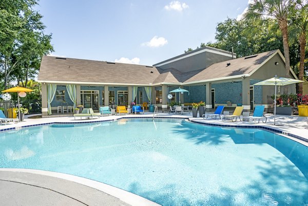 Rooftop pool with lounge chairs at Fusion Apartments luxury community