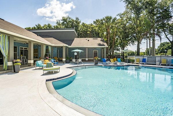 Luxury poolside leisure at Fusion Apartments with modern design and spacious seating areas