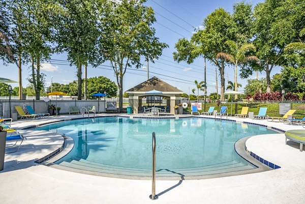 Resort-style pool area with lounging spaces at Fusion Apartments, offering a luxury retreat for residents