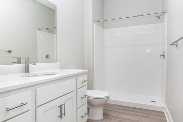 Modern bathroom with sleek fixtures featuring a stylish vanity and spacious shower at Allora 168 Apartments