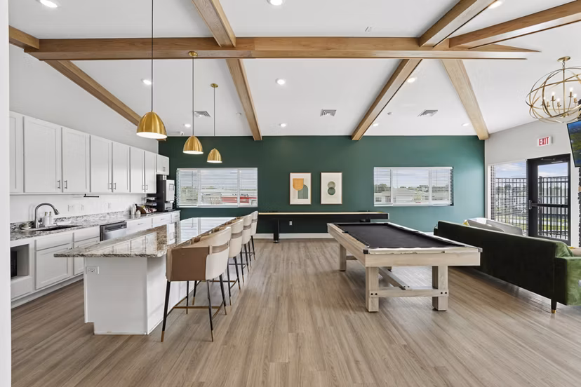 Clubhouse featuring game tables and seating at Allora 168 Apartments