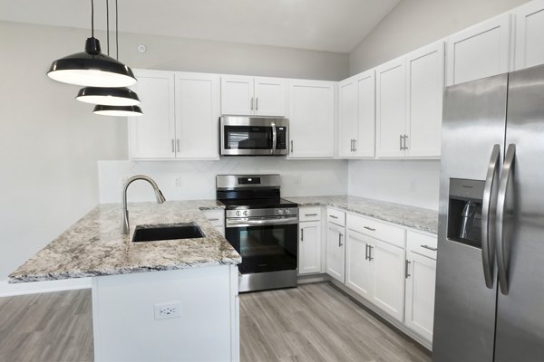Modern kitchen with stainless steel appliances at Allora 168 Apartments