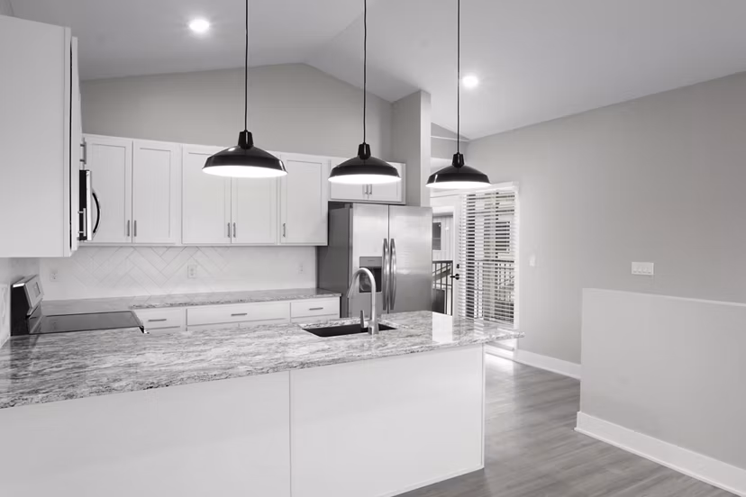 Modern kitchen featuring stainless steel appliances and granite countertops at Allora 168 Apartments