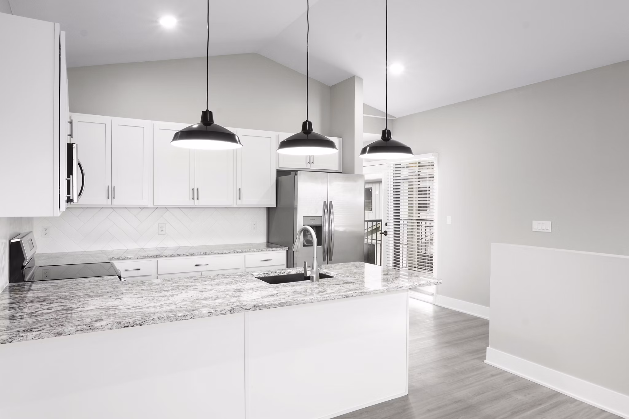 Modern kitchen featuring stainless steel appliances and granite countertops at Allora 168 Apartments